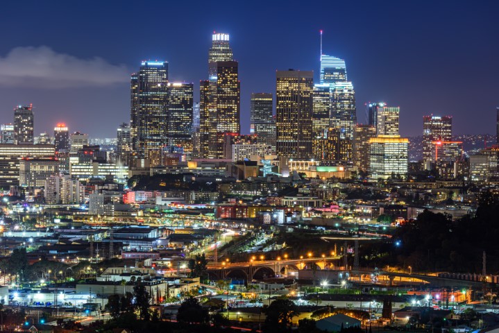 Downtown Los Angeles skyline at night, with the city’s bright lights illuminating the skyline, offering a backdrop to the vibrant LA dive bar scene in the heart of the city.