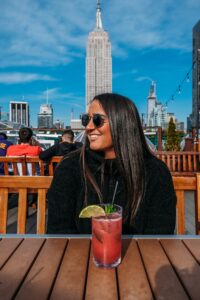 portrait of woman smiling wearing jumper on a New York Dive Bar