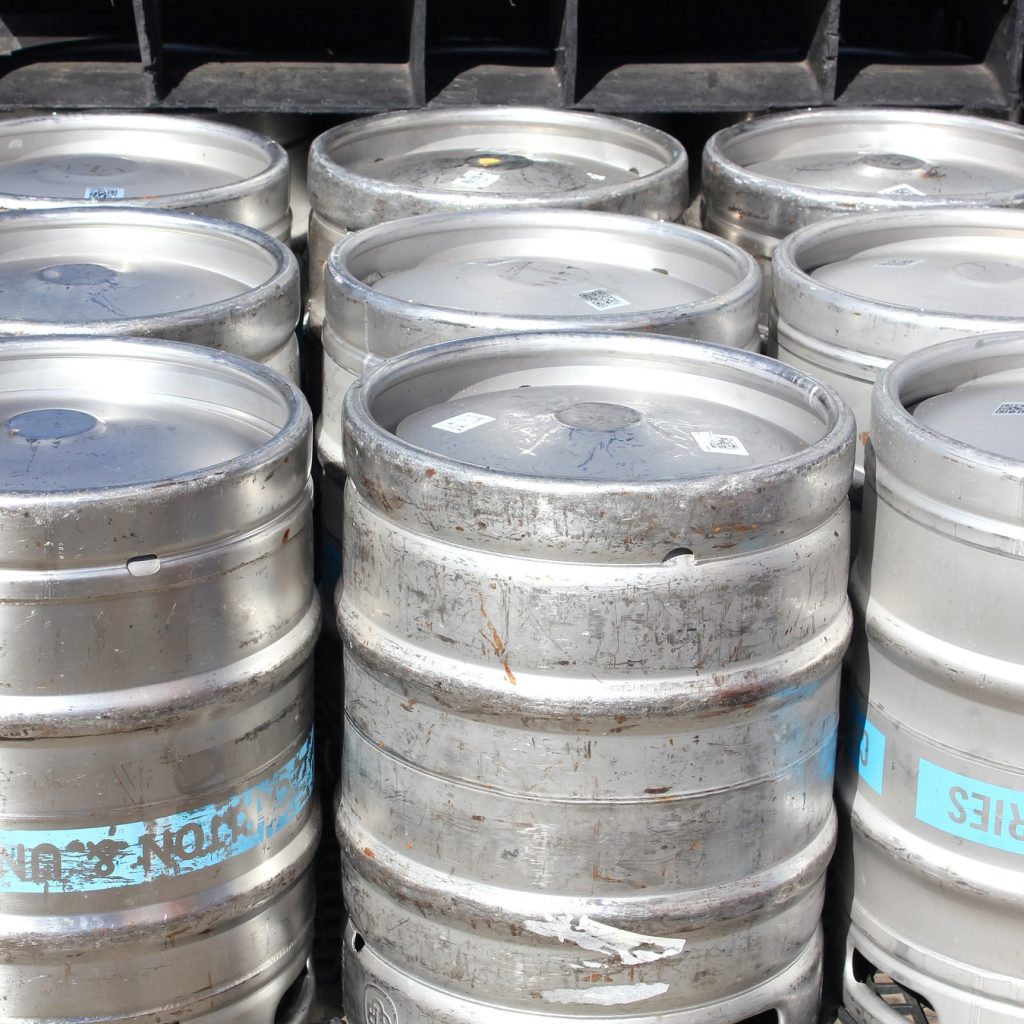 beer kegs lined up outside a brewery